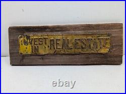Vintage INVEST IN REAL ESTATE Embossed Painted Metal Advertising Sign Antique
