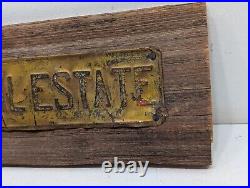 Vintage INVEST IN REAL ESTATE Embossed Painted Metal Advertising Sign Antique