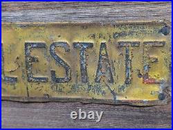 Vintage INVEST IN REAL ESTATE Embossed Painted Metal Advertising Sign Antique