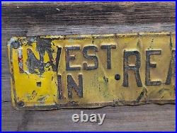 Vintage INVEST IN REAL ESTATE Embossed Painted Metal Advertising Sign Antique